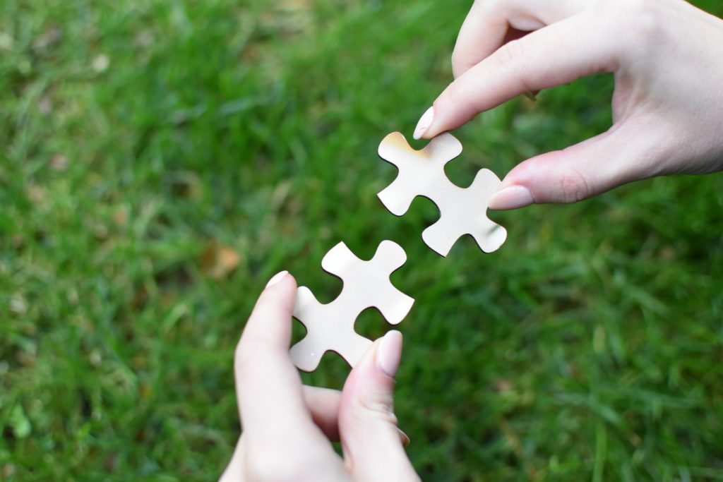 Two puzzle pieces that fit together, symbolizing the relationship that comes from a thorough RFP.